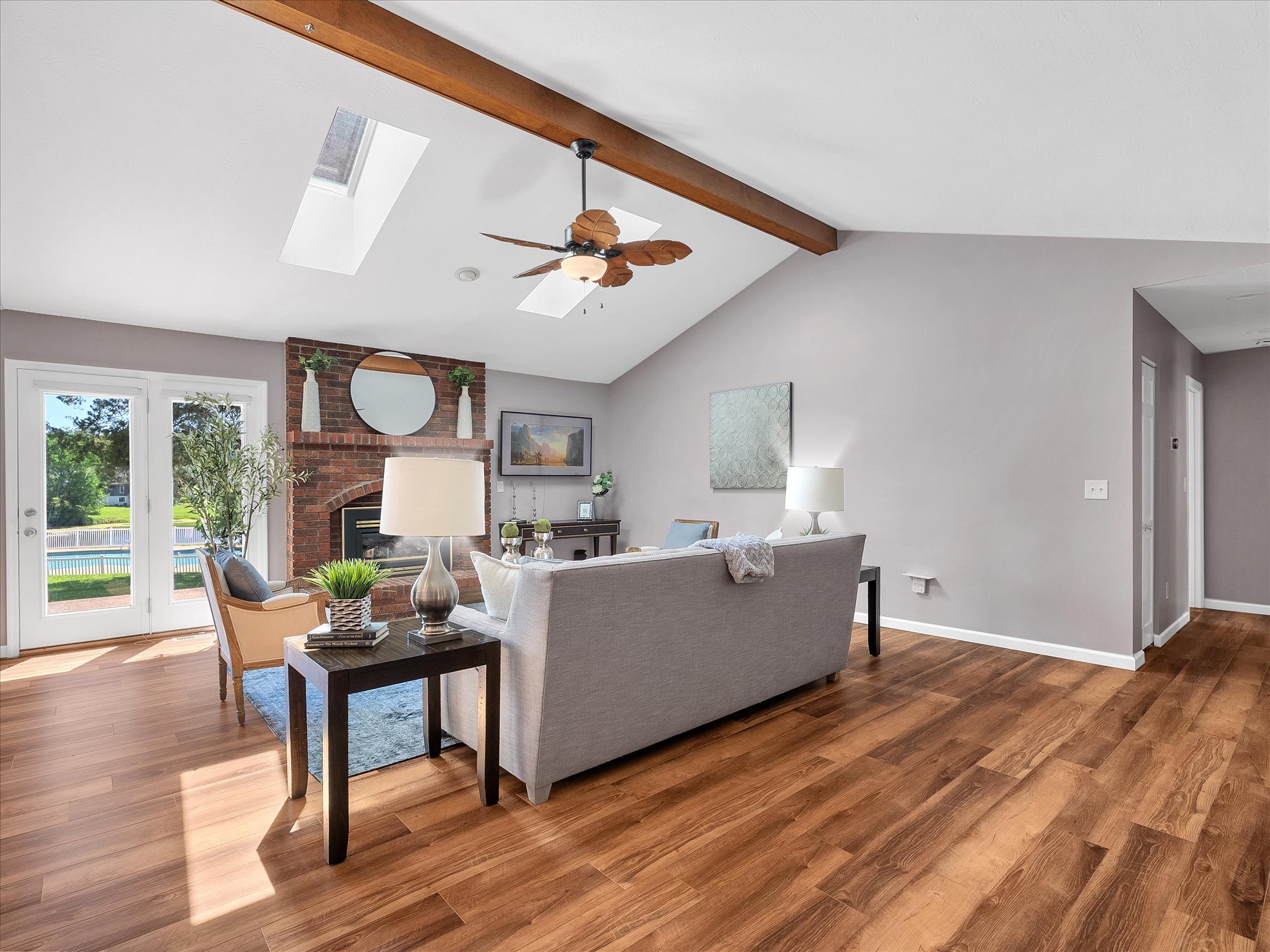 Living room with vaulted ceiling and brick fireplace