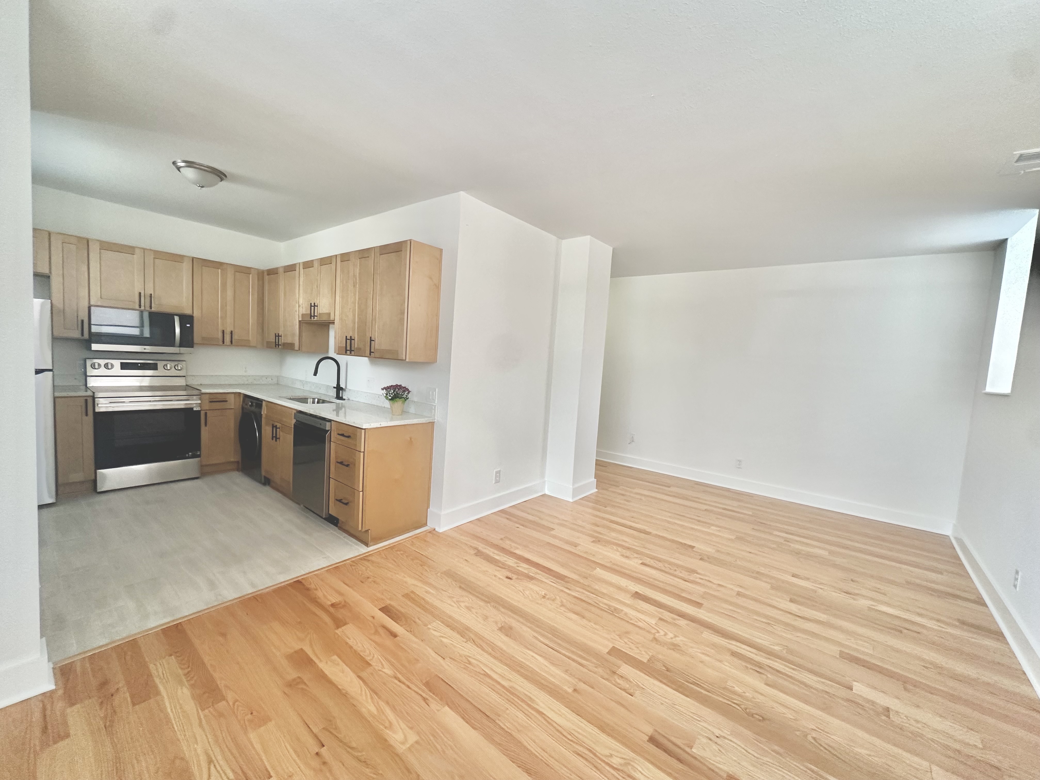 Open-plan view of the renovated kitchen and hardwood living area