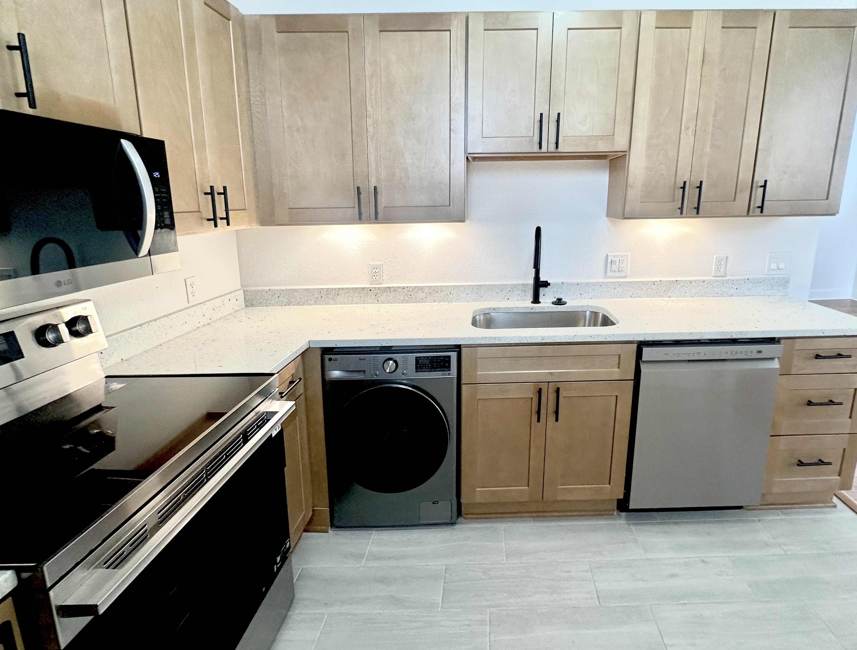 Renovated kitchen with black hardware and LG stainless appliances