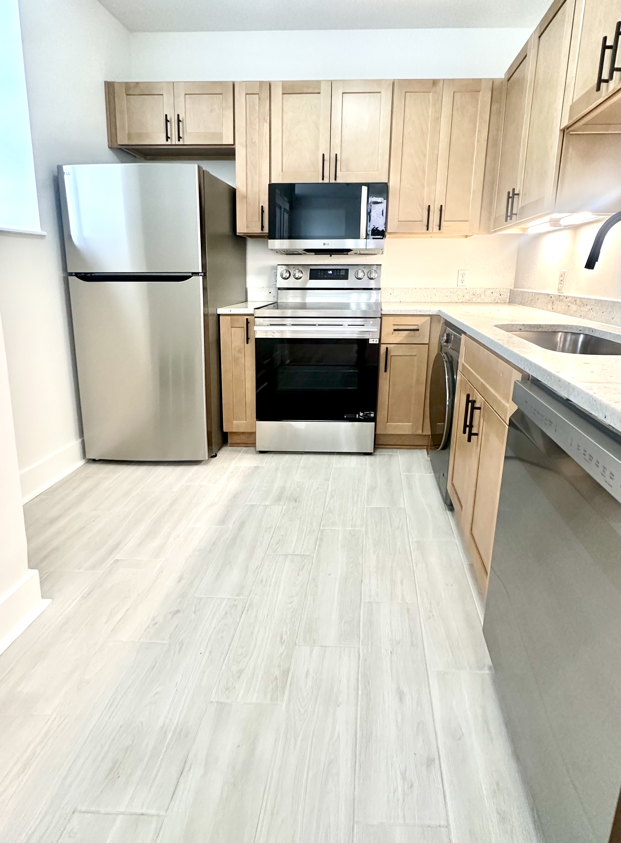 Kitchen showing LG stainless refrigerator, range, and dishwasher