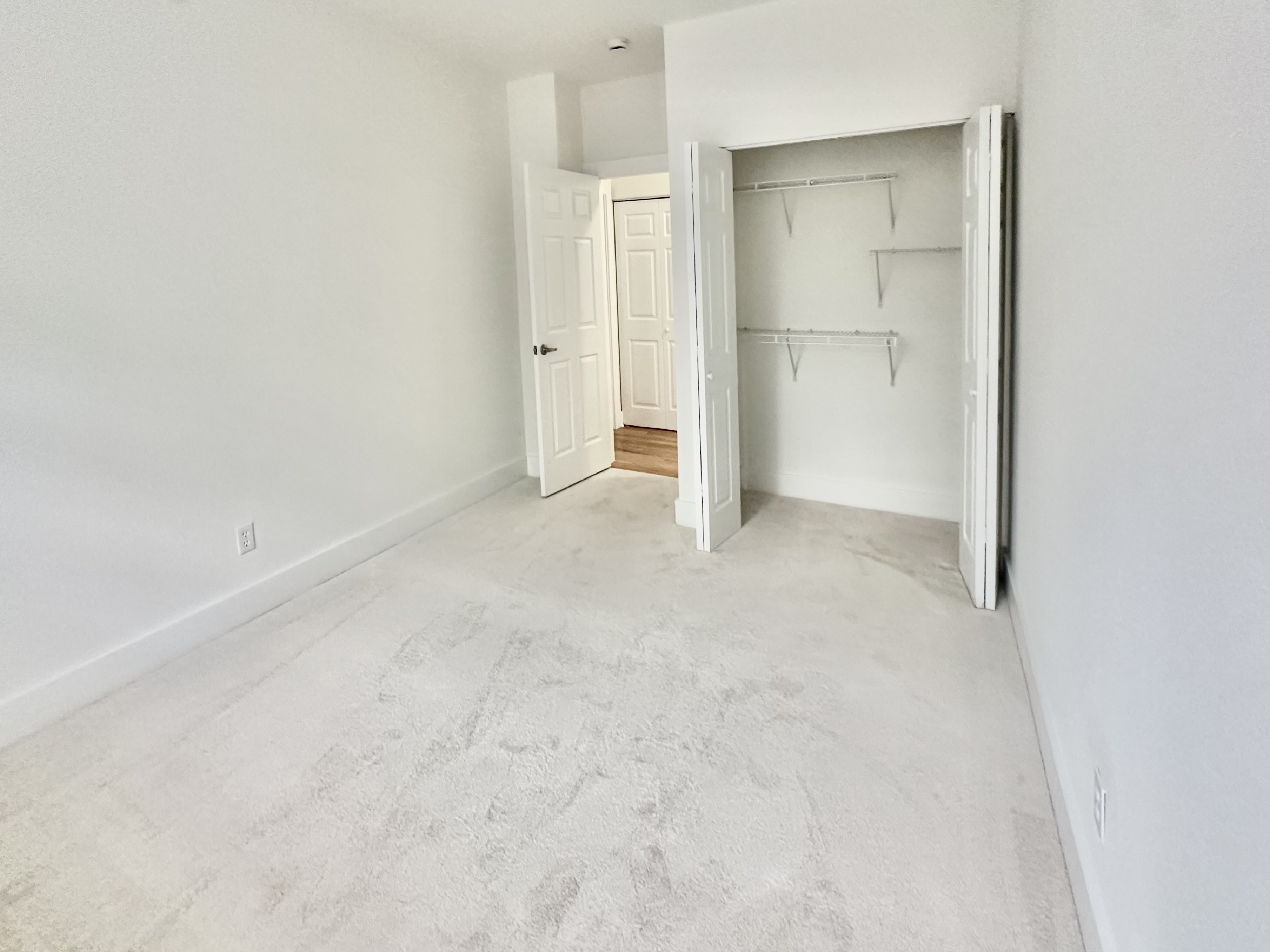 Bedroom with double-door closet and generous storage